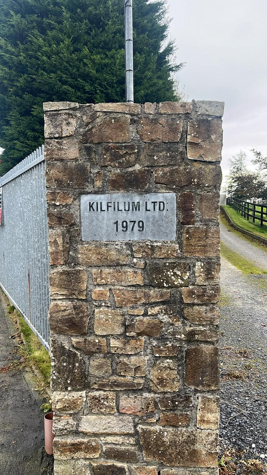 The stone entrance pillar at Kilfilum, carrying the black KILFILUM LTD. 1979 nameplate.